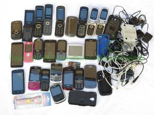 lot 16 image: Miscellaneous cell phones, including Samsung, Blackberry, LG, TCL, and more, including Tom Tom GPS and various cords.