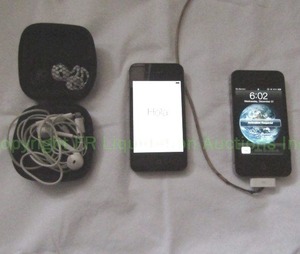 lot 23 image: Apple iPhone 4S cell phones, both power on (one needs a battery and repairs), inlcudes power cord, and Apple wired ear buds