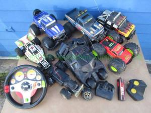 lot 76 image: RC Toy Cars with three Controllers and Hot Wheels Steering Wheel