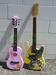 lot 122 image: Six Flags Batman electric guitar (for parts) and Disney Rapunzel childrens acoustic guitar