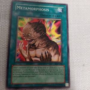 lot 53 image: SUPER RARE 1ST EDITION METAMORPHOSIS YUGIOH CARD PGD-090