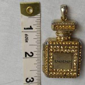 lot 72 image: BEBE PENDANT WITH CLOCK INSIDE