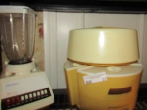 lot 37 image: Osterizer 10 speed blender, Lazy Susan, canister set