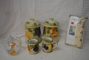 lot 18 image: Fruit Designed Cannisters, Cream and Sugar Dishes, Salt and Pepper Shakers, Orange Juice Pitcher and Dining Room Chair Cover