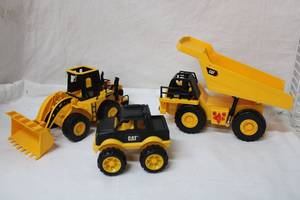 lot 91 image: Caterpillar Truck Toys - Two Larger ones have Sounds and Lights