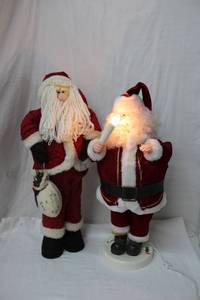 lot 106 image: Two 2ft. Standing Santas - One Plays Music and Candle Lights up