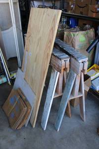 lot 111 image: Wooden Saw Horses, Georgia Pacific Plywood Board 2x4 Piece, Compost Bags, Fiberglass Piece, and Large Spikes