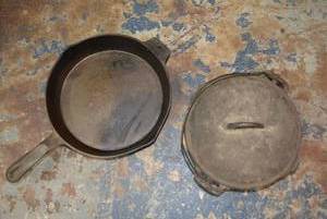 lot 134 image: Cast Iron Cookware Avid Outdoor Skillet 12 and Lidded Hanging Pot 10