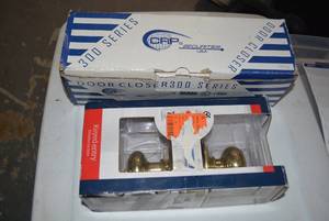 lot 138 image: Door Closer 300 Series Still in Box, Brass Doorknob Entry Kit still in Box