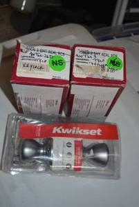 lot 140 image: Kwikset Keyed Entry Doorknob Sets - Brushed Nickel and Brass, 3 Sets Total Still in Boxes