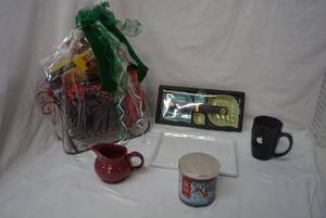 lot 288 image: Gift Lot Candle, Longaberger Mug, Yum Plate, Apple Mug,  Ceramic Tea Leaf Set, and Sleigh full of Goodies  (Not Responsible for Food - Expiration Date 722)