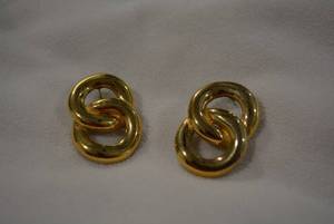 lot 331 image: Signed GIVENCHY poststud earrings featuring infinity interlocking circles. Matt gold finish. Marked Givenchy. 1.25L approx.