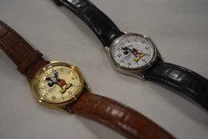 lot 332 image: (2) DISNEY Mickey Mouse watches w leather bands. Models V-896-7249-15107 (brown band) and original Disney Parks (Black band)