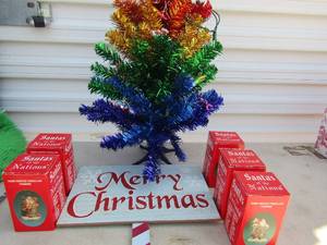 lot 31 image: Merry Christmas sign 25x12, 5 boxes of Santas of the nation Spain, Germany, Russia, USA, Sweden    21 Rainbow tree with dcor