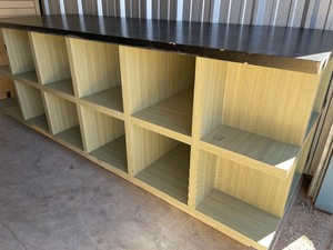 lot 173 image: COMMERCIAL GRADE DISPLAY SHELFTABLE WITH CUBBIES - FOR SHIRTS, PANTS, GAMES HAS 12 CUBBIES PER SIDE  36 H X 36D X 96 L GREEN & BLACK  - HEAVY