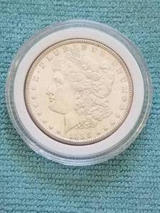lot 34 image: Morgan Silver Dollar in capsule storage case - 1883