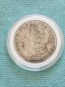 lot 49 image: Morgan Silver Dollar in capsule storage case - 1880