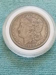 lot 100 image: Morgan Silver Dollar in capsule storage case - 1902