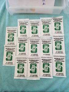 lot 136 image: Selection of 14 packs of Michigan State University trading cards