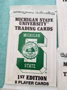 lot 231 image: Selection of 14 packs of Michigan State University trading cards