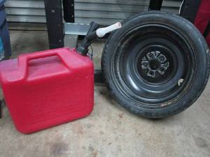 lot 22 image: 5 GALLON GAS CAN, SPARE TIRE GOODYEAR T12570D15