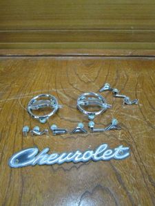 lot 79 image: &nbsp1960s IMPALA 1 SET OF FULL SIZE CHEVY QUARTER MOLDING LETTERS, PARTIAL LETTERS FOR IMPALA, 2 IMPALA EMBLEMS &amp CHEVERLET EMBLEM