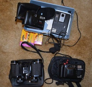lot 101 image: Tasco Binoculars, Pentax PC-303 Camera, Kodak Film Roll unopened, Nikon Fun Touch 3 Camera, Kodak disc 3000 Camera