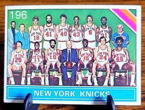 lot 196 image: 1975 Topps #215 New York Knicks Team Checklist- Bradley, Frazier, Monroe - NMMT