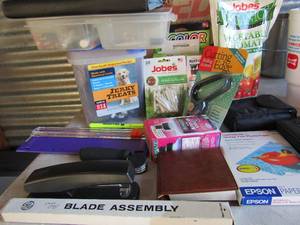 lot 79 image: Books for notes and apps, Stapters, 4x6 photo paper, paper cutter blade assembly and plant fertilizer because why not