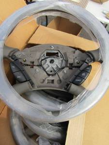 lot 105 image: Box of 4 Ford steering wheels with cruise