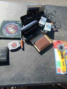 lot 117 image: Chambers silver belt buckle, Black Cowhide wallet, Brown Dockers wallet, 2 digital battery chargers, NEW Rotary radio controlled electric alarm clock