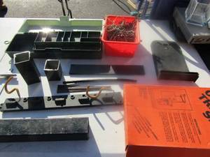 lot 127 image: Misc. metal pieces, used DMI over door traction set, screws, bolts, hooks, tool caddy and sprinkler