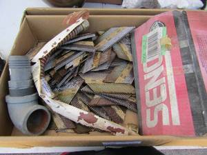 lot 144 image: Box full of nail gun strips roofing and framing nails