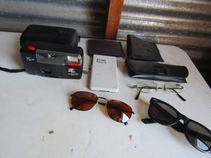 lot 207 image: Lot of sunglasses, mens wallet and autofocus polaroid pens