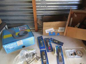 lot 218 image: NEW pushbutton lighted door handles, door knobs, locks, box of flexco wall base 50 coils