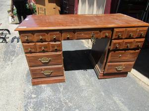 lot 265 image: Brown desk 3 drawers on east side 1 middle drawer handles needs repair