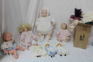lot 101 image: Porcelain Dolls Babies, 4 Dolls, extra Doll Outfits