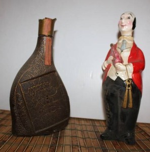 lot 245 image: Vintage Ceramic Wine Server marked Japan with Double Arrow Symbol, and Glass Modern Masters Bottle