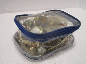 lot 127 image: CLEAR BAG WITH BLUE ZIPPER FILLED WITH FASHION JEWELRY, CONTENTS INCLUDED.&nbsp