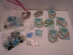lot 129 image: JEWELRY BEADS- NEW PACKAGED VARIETY OF PEARL BEAD STRANDS &amp BAGS OF DIFFERENT BEADS.