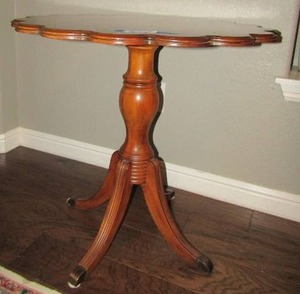 lot 12 image: SCALLOPED WALNUT OCCASIONAL TABLE MARQUETRY INLAY AND BRASS FEET 28 BY 27