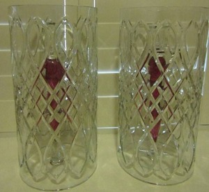 lot 88 image: CRANBERRY GLASS AND CRYSTAL TWIST CANDLE HOLDERS 15IN HEIGHT QTY 2 AND PRESS GLASS BROWN PILLER CANDLE COVERS 16 BY 9 QTY 2