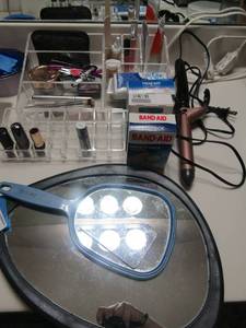 lot 111 image: MAKE UP MIRROR HAND HELD USED PACKS BANDAIDS USED MAKE UP