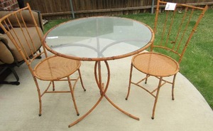 lot 153 image: METAL ORANGE WICKER CANE STYLE PATIO FURNITURE  - TWO CHAIRS  & GLASS TOP TABLE  SIZE OF TABLE 21 X 29