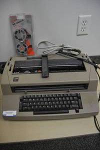 lot 54 image: Vintage IBM Selectric III Typewriter with Extra Ribbon Cartridge