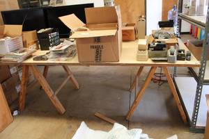 lot 457 image: Homemade Work Table 8Ft.x 4Ft. Board and 2 Wooden Saw Horses (Contents Not Included)