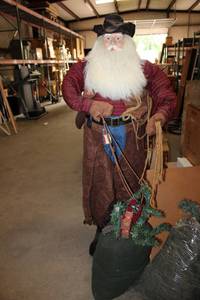 lot 580 image: Life-Size Western Santa Suede Vest and Chaps, Flannel Shirt, Bag of Toys (Still with Tag designed by Tina Mitchell)