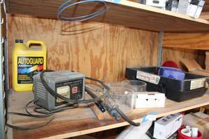 lot 827 image: Battery Charger, Gallon of AntiFreeze, Oil Changing Tub