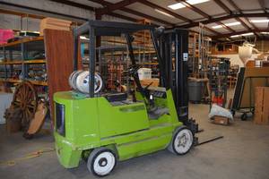 lot 17 image: Green Forklift by Clark (was used during auction set-up) Odometer Reads 8,311.1 Hours