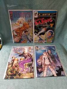 lot 14 image: Selection of 4 comic books - Xenotech, Captain Daring, Mystic, and Fathom